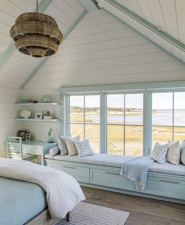 Bedroom window seat with custom cabinets below and overlooking the water